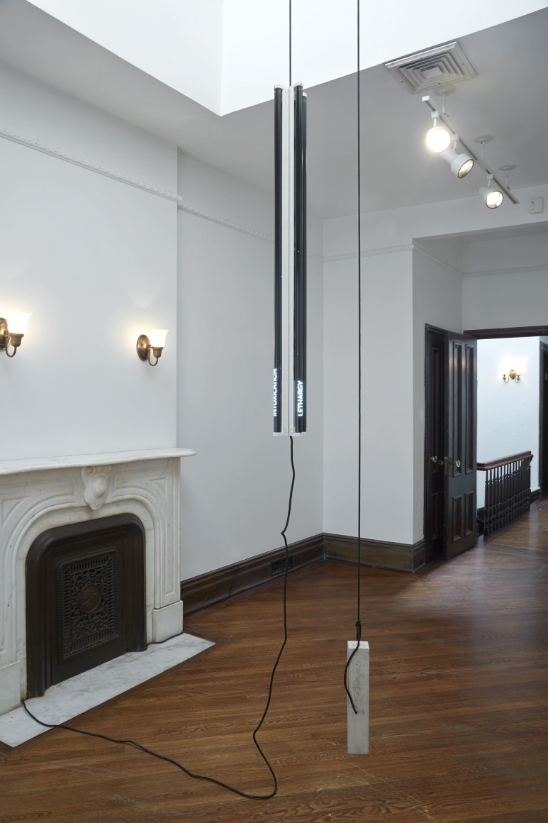 installation by matthias bitzer featuring fluorescent lights dangling from the ceiling