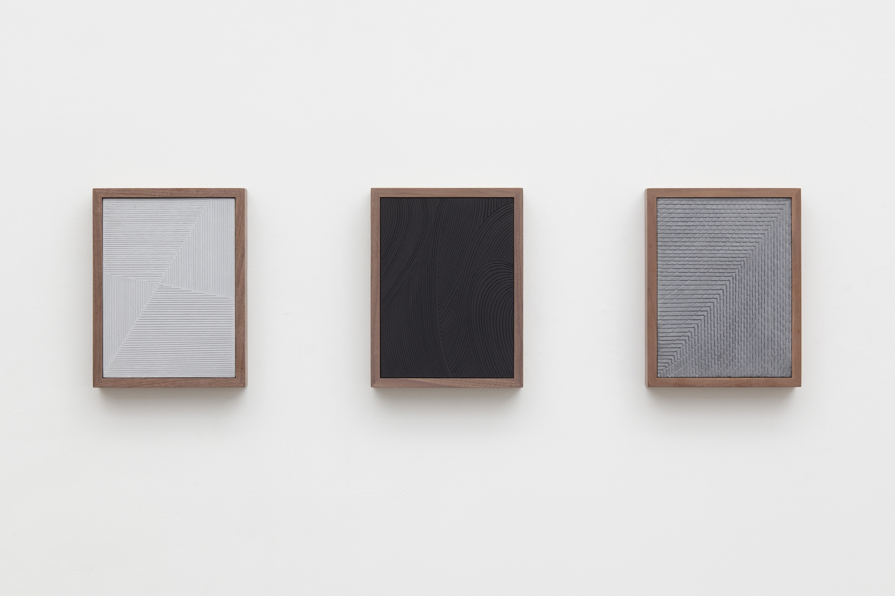 three grey and black paintings in a triptych by anthony pearson