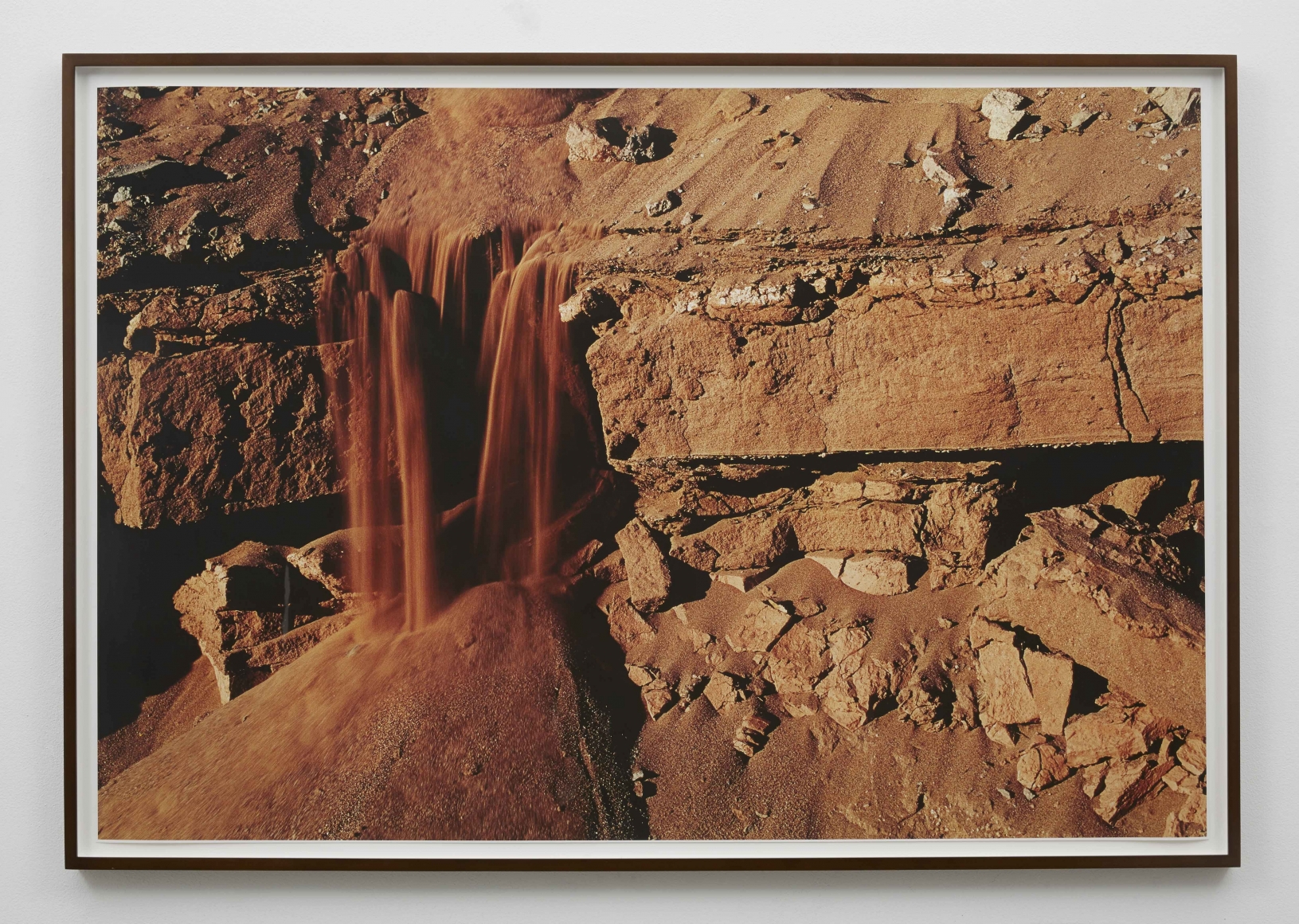a photograph of sand falling down a landscape by brazilian artist thiago rocha pitta