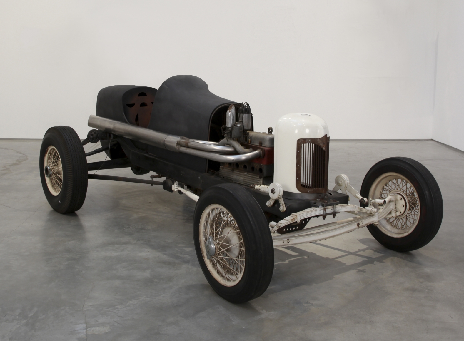 a race car by salvatore scarpitta exhibited in a contemporary art gallery