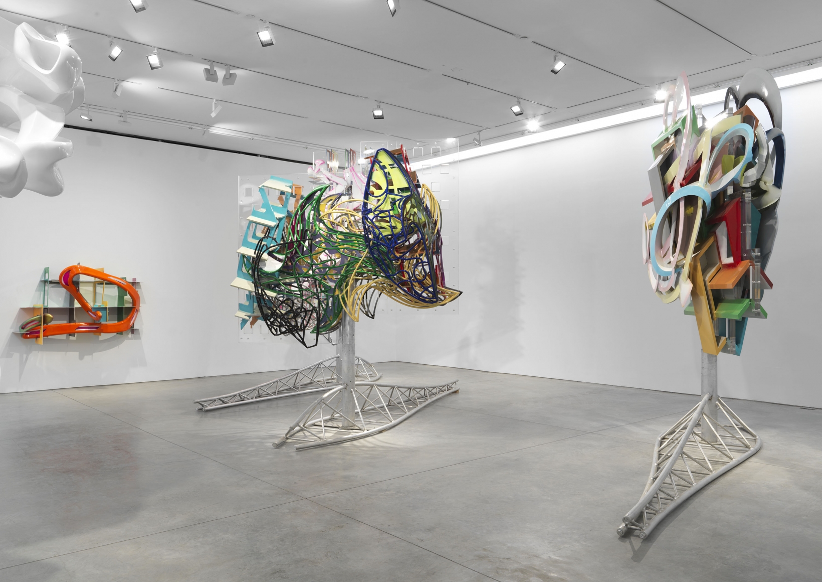 Colorful kinetic sculptures that can rotate and are on steel bases, made by Frank Stella