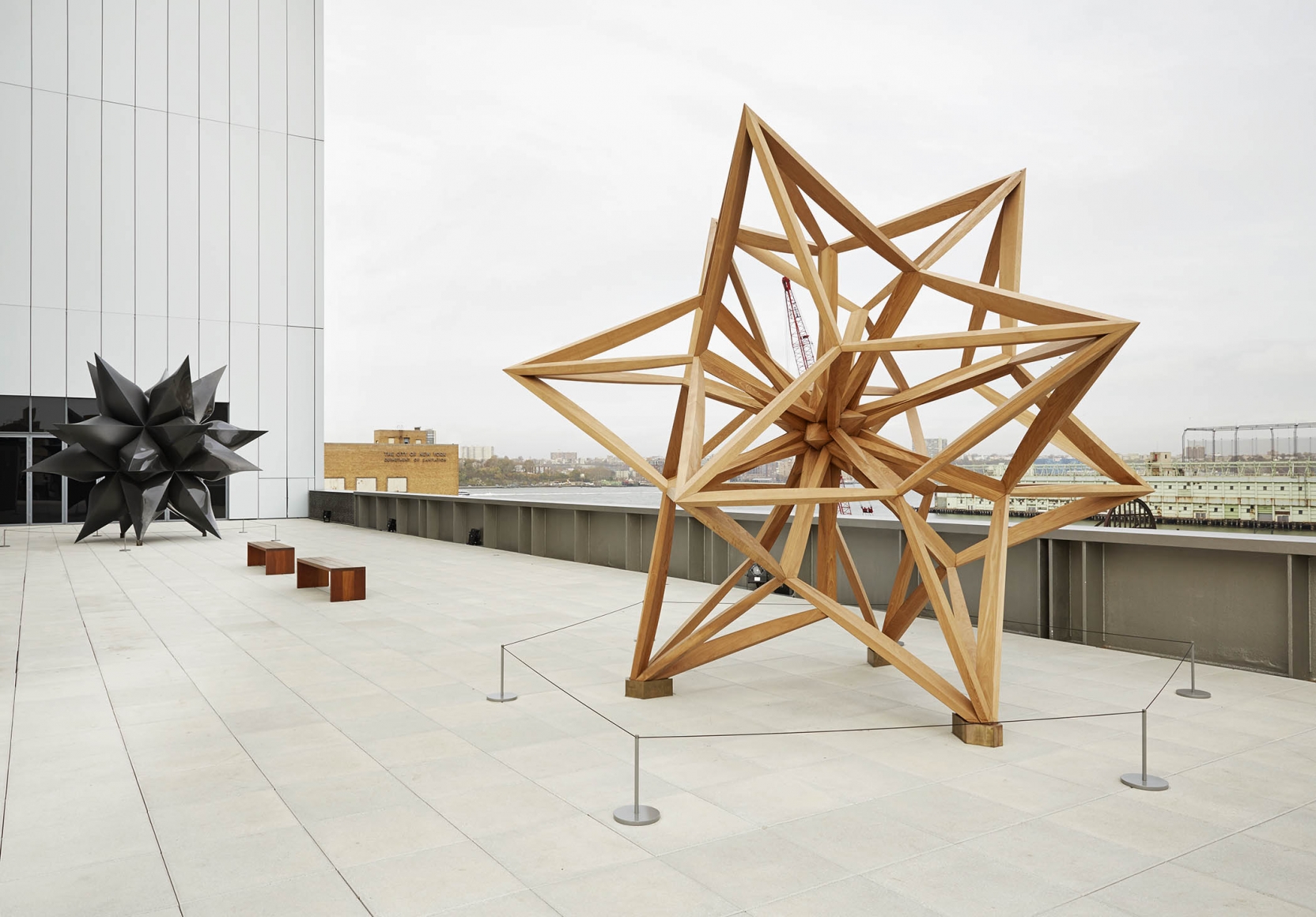 A wooden star by frank stella on a rooftop of the whitney museum of art