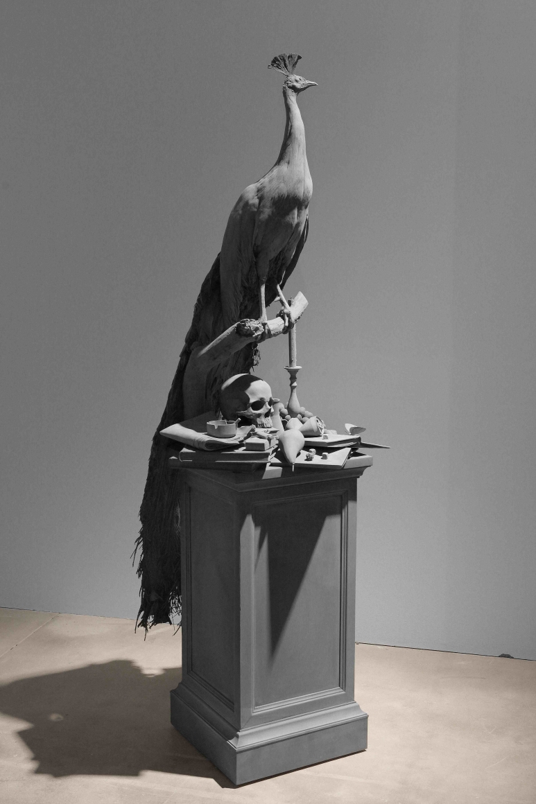 a sculpture of a peacock by Hans Op de Beeck as part of a contemporary art exhibition