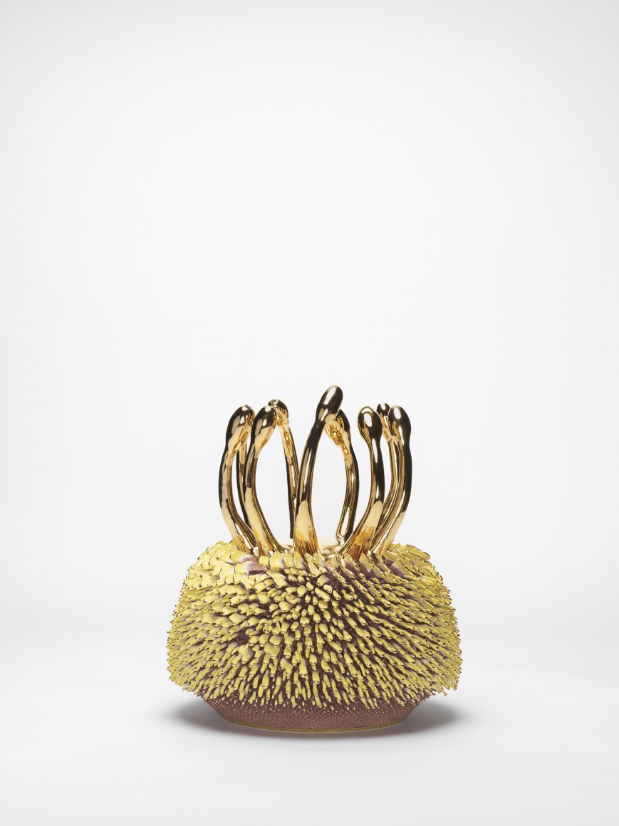 Yellow and pink porcelain sculpture with gold accents by the artists the haas brothers
