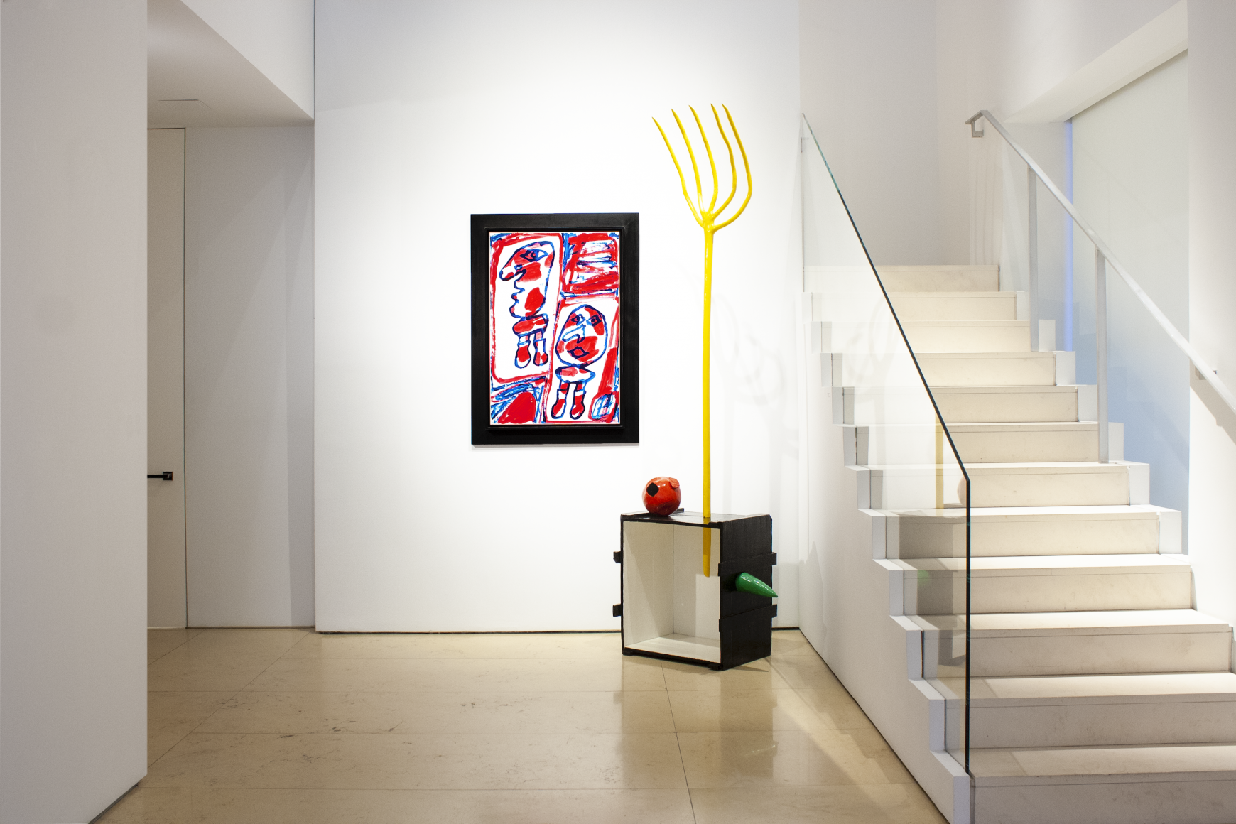 This is the view of the front wall of the lobby entrance which features a painting bt Jean Dubuffet and a sculpture by Joan Miro. We can see the stairs on the right.