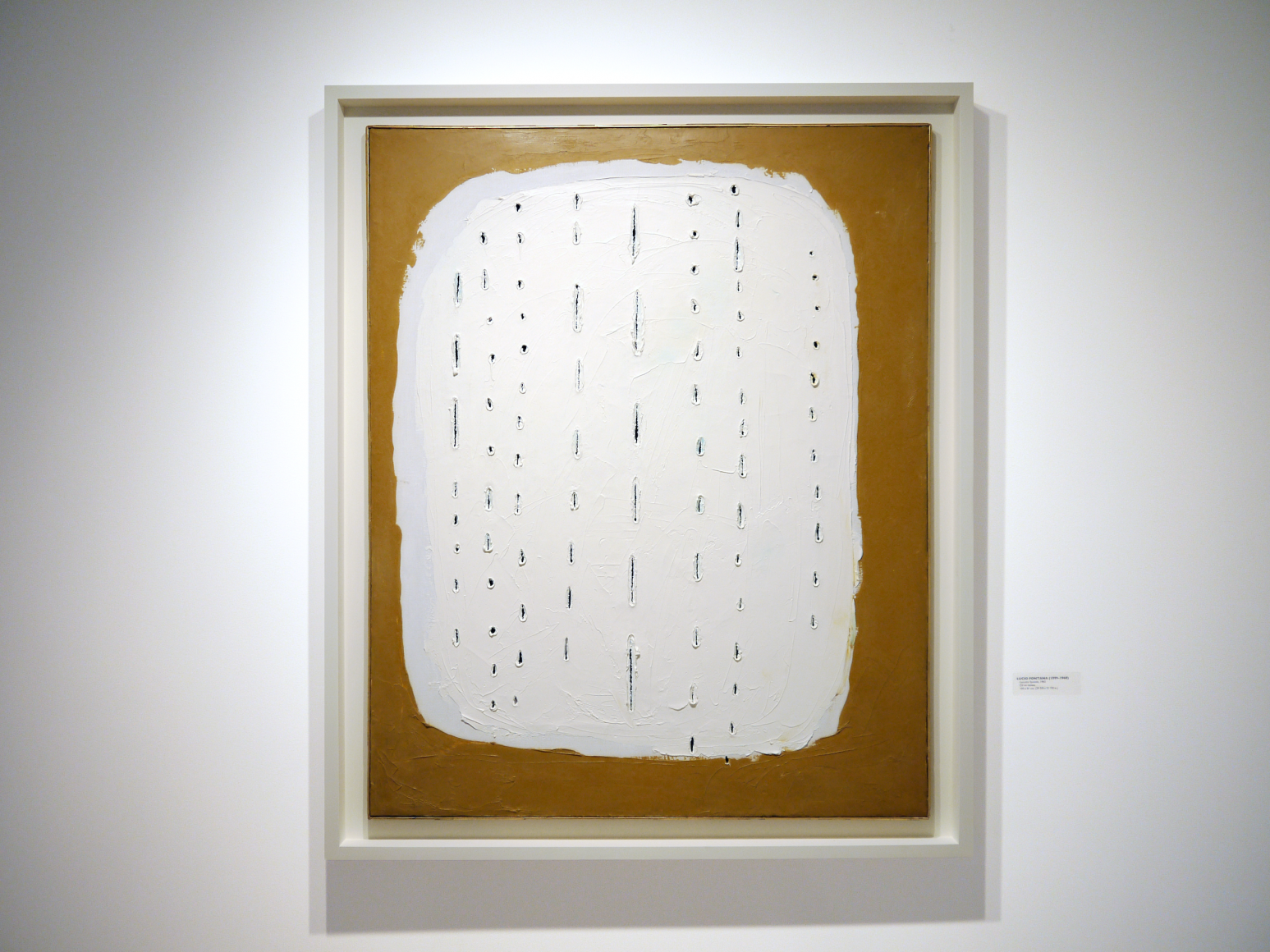 Installation view of Selected Works by 20th Century Masters featuring Lucio Fontana, Concetto Spaziale, 1960, Oil on canvas, 100 x 81 cm. (39 ⅜ x 31 ⅞ in.) Photography by Bianca Boragi. ©Helly Nahmad Gallery NY.