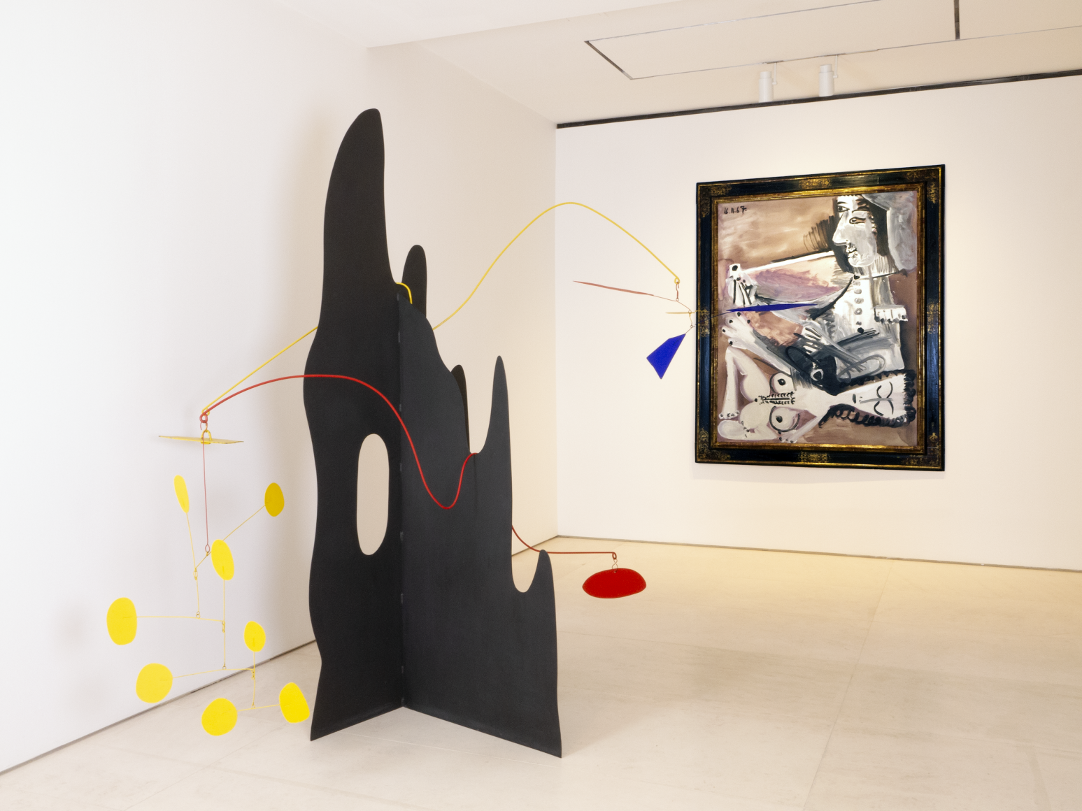 his is an image of a large scale Crag sculpture by Calder and a painting by Picasso from the painter and model series.