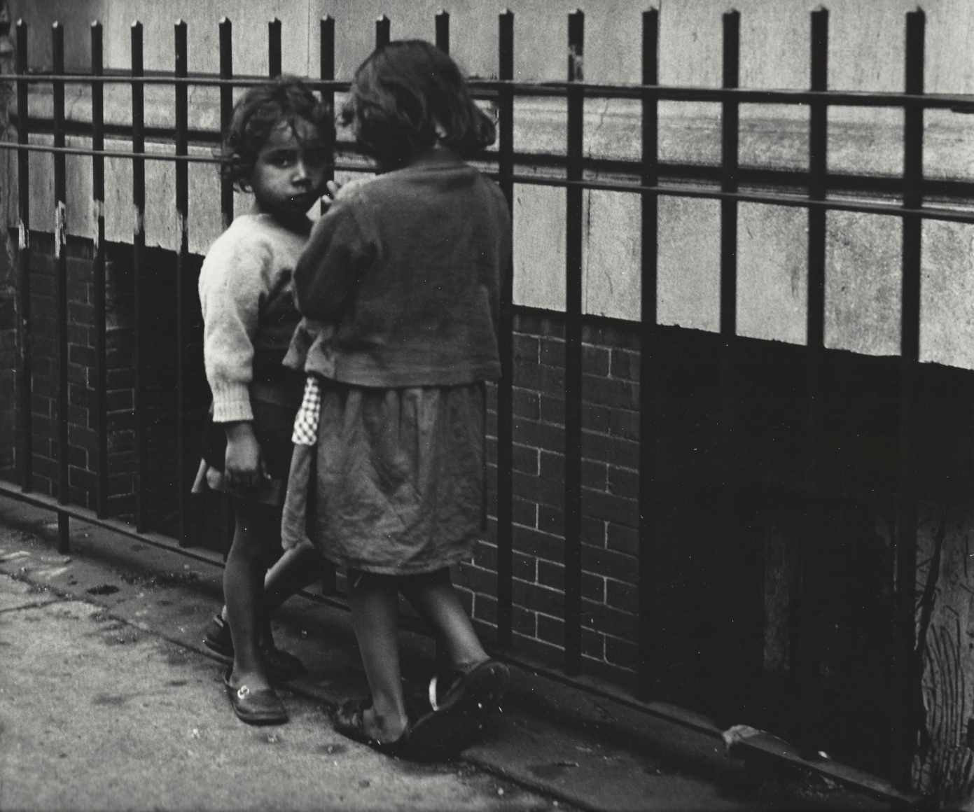 Two girls by fence by Vivian Cherry