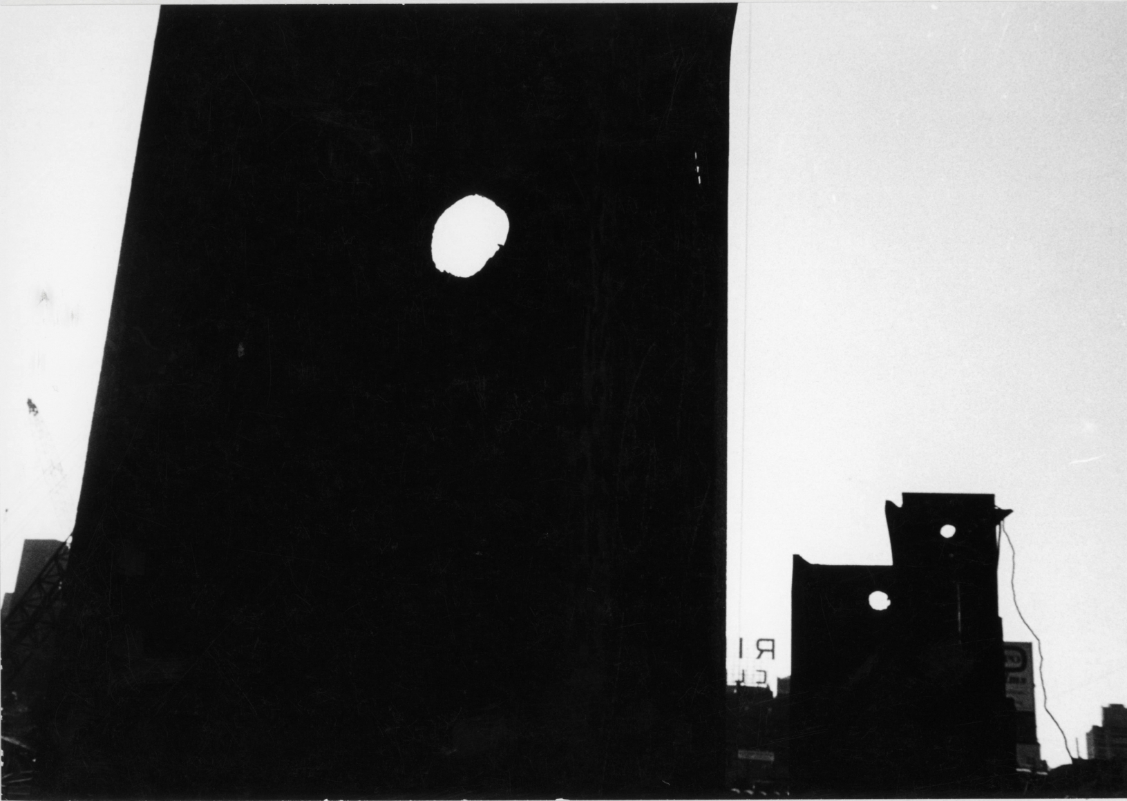 Louis Draper, Untitled (Dark silhouettes of buildings with three round holes, sign with "RI"), n.d