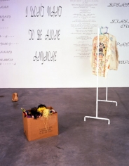 Mike Kelley, Written in the Wind, 1991 (Detail). Cardboard box, 10 found stuffed animals, coat rack with jacket & shirt, ten wall texts, dimensions variable. MP 9180
