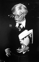 Anton Perich, Andy Warhol holding newspaper, circa 1975