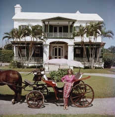 Slim Aarons, Bermudan Hostess: Polly Trott Hornburg in front of her father's house, 1957