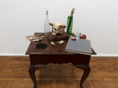 Merik Goma Memento Mori, 2019 Table, books, paints, plastic skull, flower crown, glass Installed dimensions variable