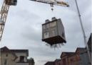 Roots trail from house suspended above a construction site by Leandro Erlich