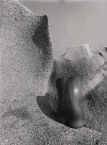 Pino Dal Gal, Capo Testa (Sardinia), 1977. Abstracted nude torso photographed from behind against a stone landscape.