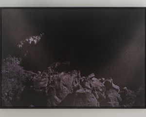 A photograph of a mountainous landscape in purple tones