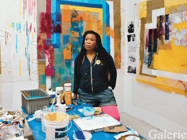 Tomashi Jackson in her studio surrounded by her colorful-layered assemblages. Jeremy Liebman