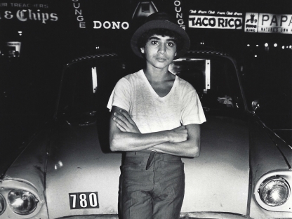Boy leaning on taxi by Arlene Gottfried