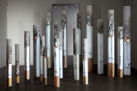 Marlboro, Camel, Winston, Parliament, Salem, Marlboro Light, American Spirit, 2009. PVC tubes, video projection, dimensions variable (largest: 83 inches high; smallest: 50 inches high. MP 587