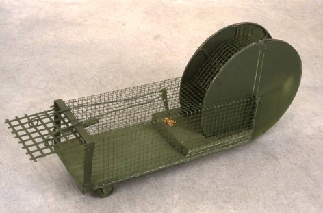 Fox of Dog Trap, 1998. Metal, bait, (trap) 18-1/2 x 14-1/4 x 14-1/4 inches. MP 7