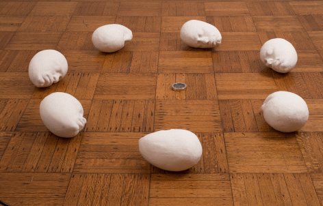 Fred Holland "Compass", 2015 Cast plaster heads and toy compass 6 x 58 x 58 inches