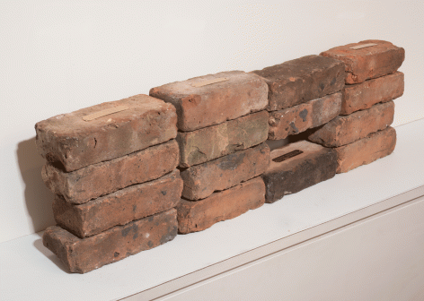 Fred Holland "When...", 2015 Used brick, engraved brass plate, and thin cardboard 9-1/2 x 32-3/4 x 3-1/2 inches (installed dimensions) 2-1/2 x 8 x 3-1/2 inches (each brick)