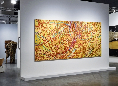 Art fair booth featuring sculpture and paintings