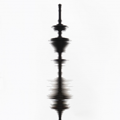 a sculpture by Elizabeth Turk of black aluminum discs stacked and arranged to simultaneously resemble a Modernist abstraction and a sound wave