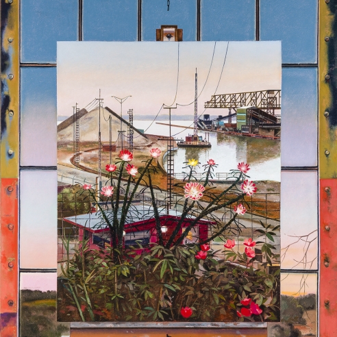 a landscape painting on an easel in front of an industrial window