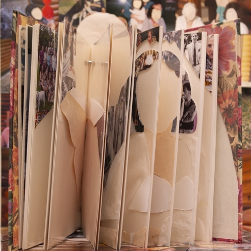 photograph of a family album where pictures have been cutout to create a portrait of a couple