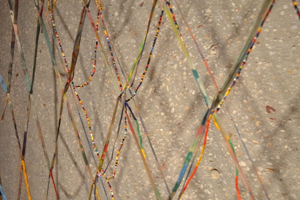 a close up of a bead and canvas work by Alan Shields