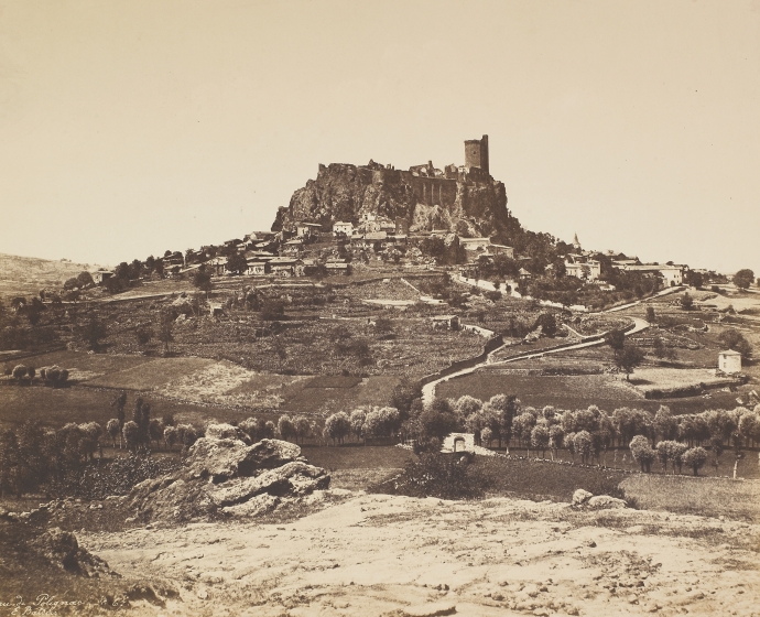 Édouard BALDUS (French, 1813-1889) "Château de Polignac", 1850s Coated salt print from a paper negative 32.6 x 44.7 cm mounted on 44.9 x 59.9 cm paper Signed "E. Baldus.", titled "Château de Polignac" and numbered "No 67" in the negative. "E. Baldus" blue signature stamp on mount.