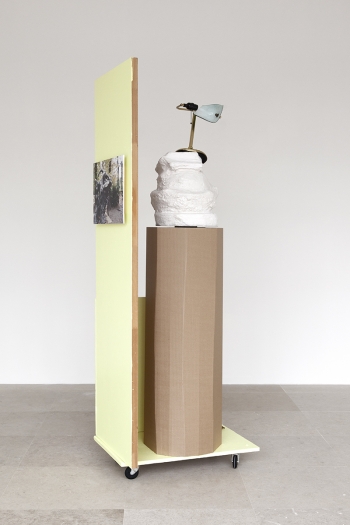 Rachel Harrison, The Fourth Shade, 2000, Wood, polystyrene, cement, acrylic, cardboard, hollow core door, lamp, wheels, and chromogenic print, 85 x 32 x 24 inches