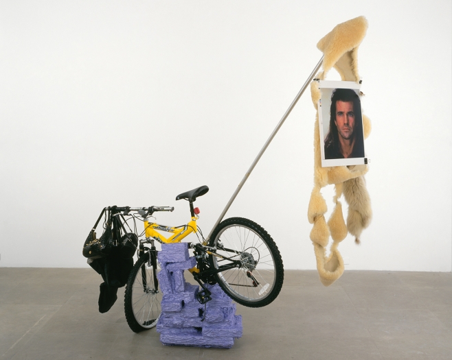 Rachel Harrison Huffy Howler, 2004 Wood, polystyrene, cement, acrylic, Huffy Howler bicycle, handbags, rocks, brick, sheepskin fur, metal pole, wire, pigmented inkjet print, binder clips 84 x 84 x 30 inches (213.4 x 213.4 x 76.2 cm)