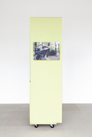Rachel Harrison, The Fourth Shade, 2000, Wood, polystyrene, cement, acrylic, cardboard, hollow core door, lamp, wheels, and chromogenic print, 85 x 32 x 24 inches