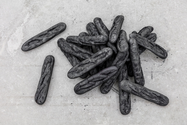 Man, 2017. Burnt baguettes, Dimensions variable.