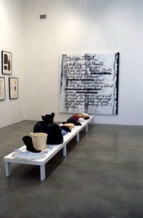 Mike Kelley and Tony Oursler, Things to Get, 1997. Found objects on wood platform, spray paint, enamel paint on canvas; platform: 12 x 25-3/8 x 162 inches, painting: 84 x 83 inches. MP 1