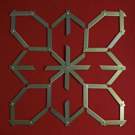 Abdullah M. I. Syed Margin of Error - Rosette on Red, 2017, Titanium utility knife blades, brass, stainless steel, felt and tempered hardwood, 23 x 23 in