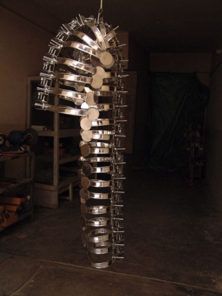 Adeela Suleman, Remains, 2008, Steel drain covers, steel tongs, nuts and bolts, 44 x 16 in