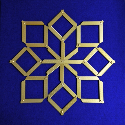 Abdullah M. I. Syed Margin of Error - Rosette on Blue, 2017, Titanium utility knife blades, brass, stainless steel, felt and tempered hardwood, 23 x 23 in