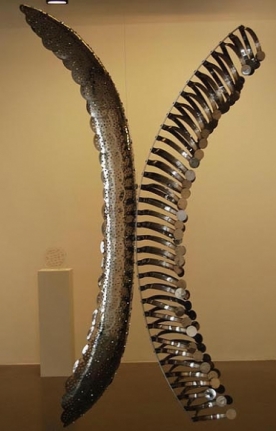 Adeela Suleman CONFLICTING SIDES 2009 Steel drain cover, steel tongs, nuts & bolts (two separate pieces but to be displayed as shown in image 1) Piece 1 (left) 81.5 x 14 x 22 (depth) in.; Piece 2 (right): 78 x 11 x 19 (depth) in.