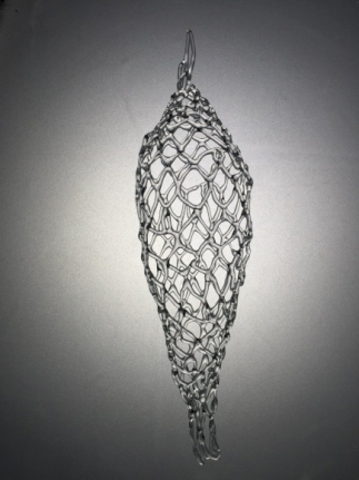 Glass sculpture with a very intricate checkerboard structure.