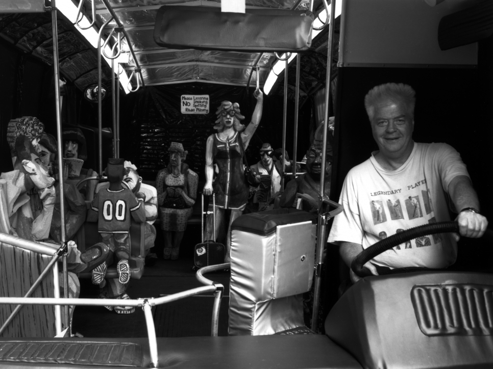 Black and white photographic portrait of Red Grooms on The Bus, 1995
