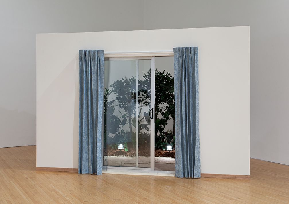 California Patio, 1972, Artificial plants, Malibu lights, flagstone, slider, curtains, wooden wall, and text