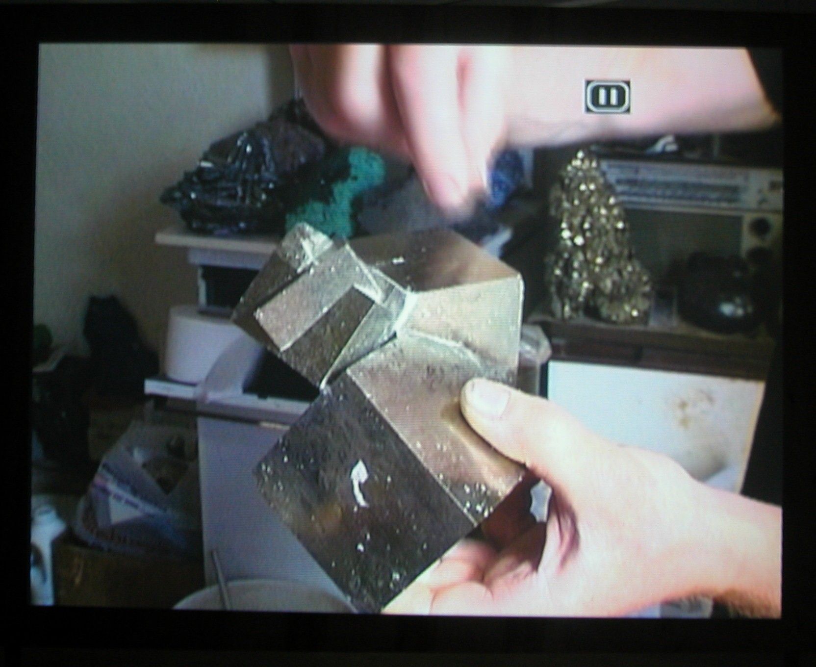 Quarry, 2003 (still), Two Parts: “Blast” (4 minutes), “Dr. Chris Alabaster” (12 minutes), 2 DVDs, bleachers, wooden screen, Installation dimensions variable