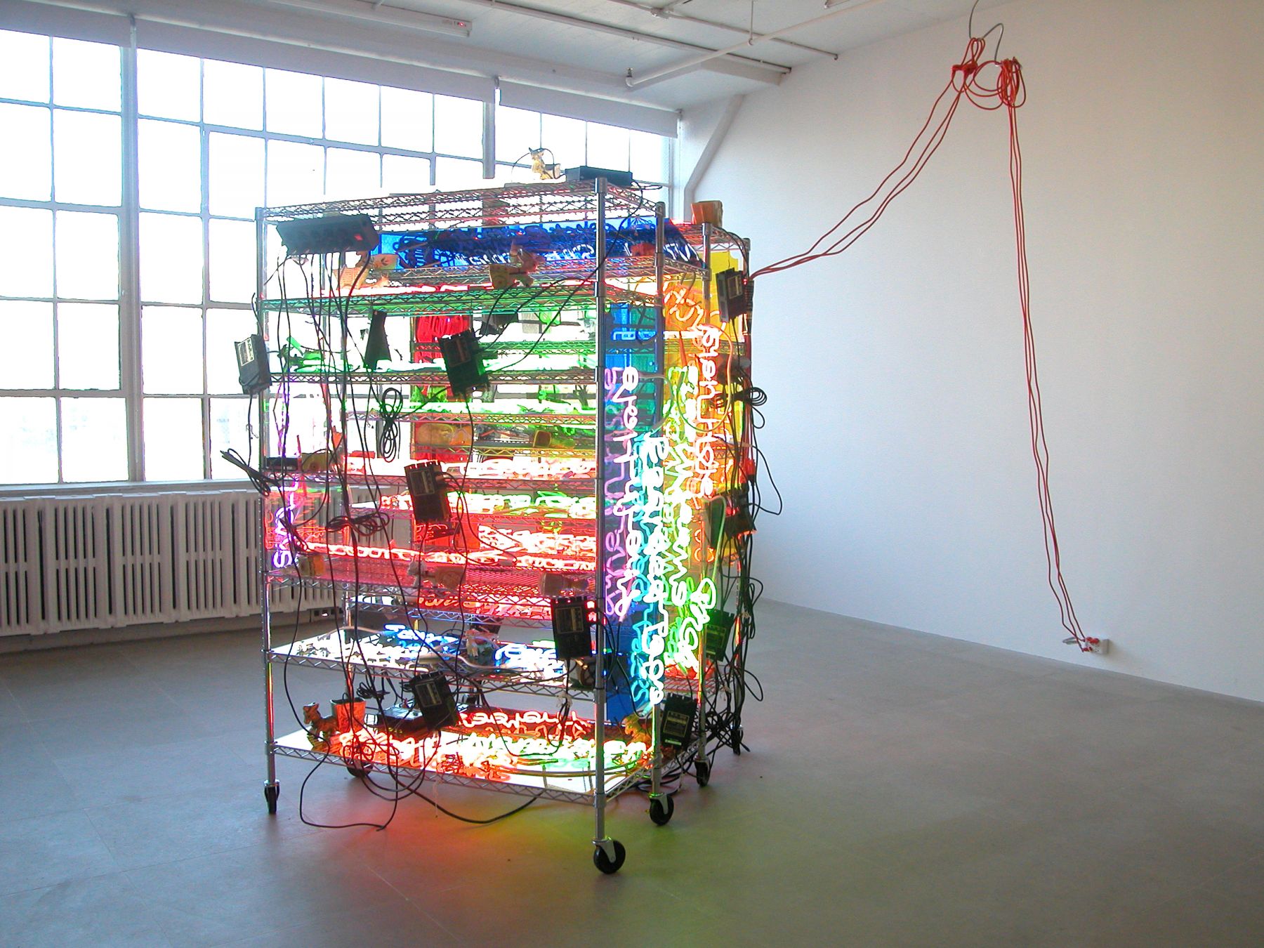 Jason Rhoades, Shelf (Love Pocket), 2003 (detail), Seville Ultra Durable chrome shelving system with 17 shelves, 23 neon panels, 41 ceramic donkey carts, 3 power strips, 3 orange extension cables, 14 metal hooks, 83 x 54 x 24 inches