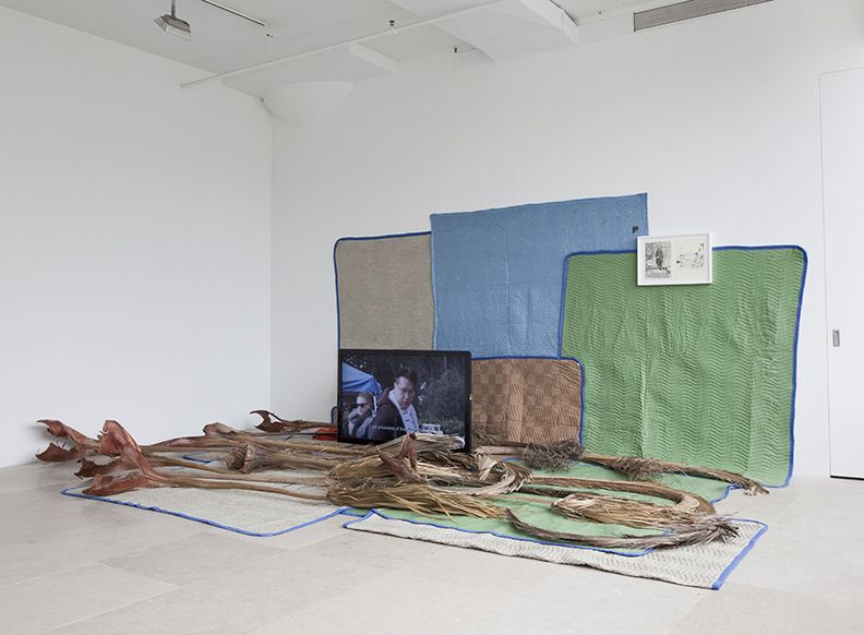 FREAK OUT, Koki Tanaka, Someones junk is someone elses treasure, 2011, Digital video projections w/ sound, palm fronds, moving blankets, money box, framed drawing, dimensions variable