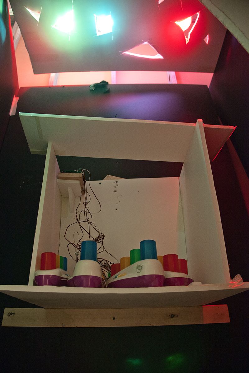 Gedi Sibony, Jeweled Repetitiously, 2013, Canvas, colored lights, little room, Baby Bach pianos, programmed circuit board, wires, batteries, 107 x 52 x 32 inches