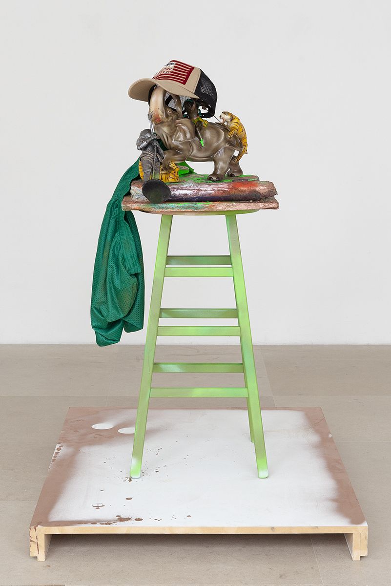Rachel Harrison Before You Have To, 2018 Wood, cement, polystyrene, acrylic, enamel, glass, figurines, mesh shorts, hat, log, and stool 46 x 26 3/8 x 38 inches (116.8 x 67 x 96.5 cm)