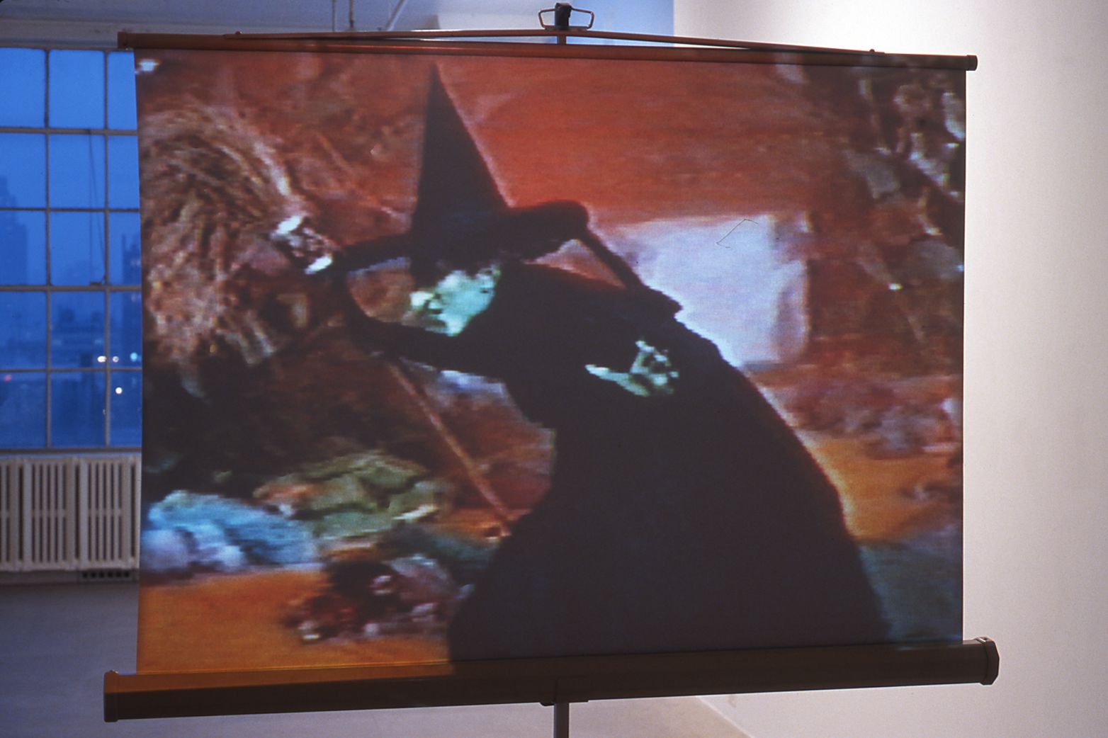 Julie Becker, Suburban Legend, 1999, 1 Beta Master tape, 1 vhs viewing copy, 1 metal homemovie screen, 1 vcr with time clock, 2 headphone sets, wood shelf unit and bench, 3 Suburban Legend manuals
